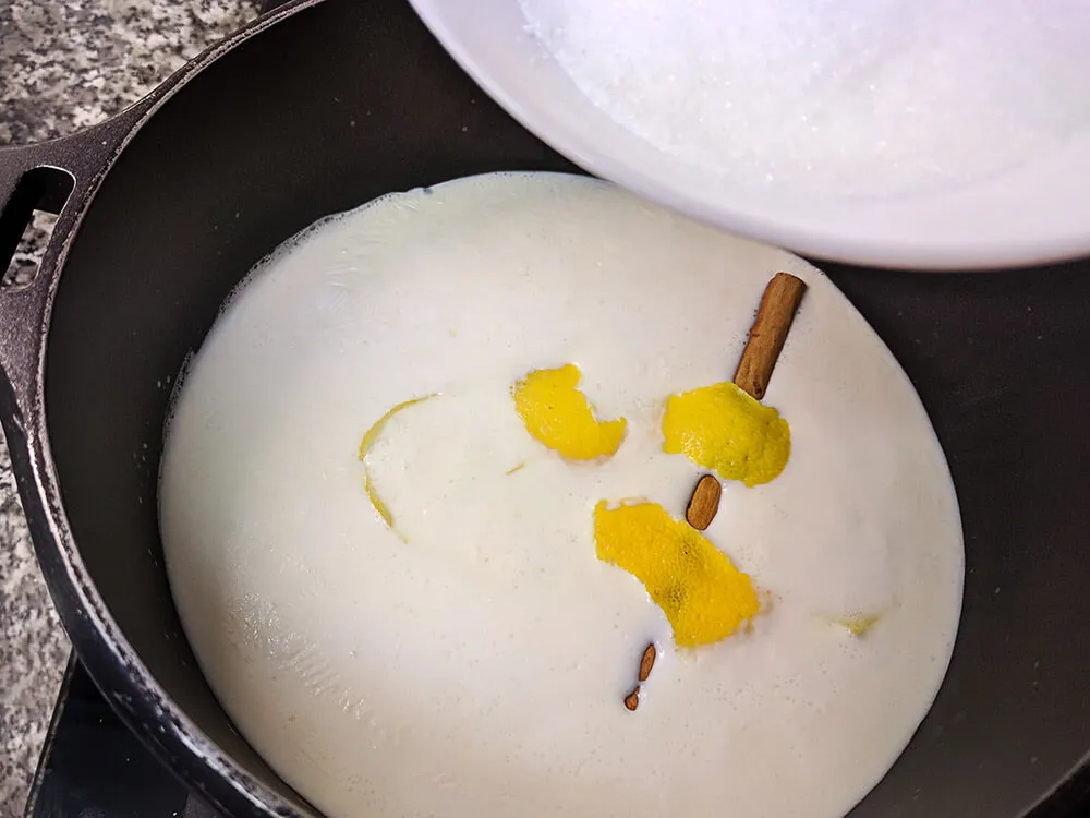 Leche, crema de leche, corteza de limón, canela y azúcar.