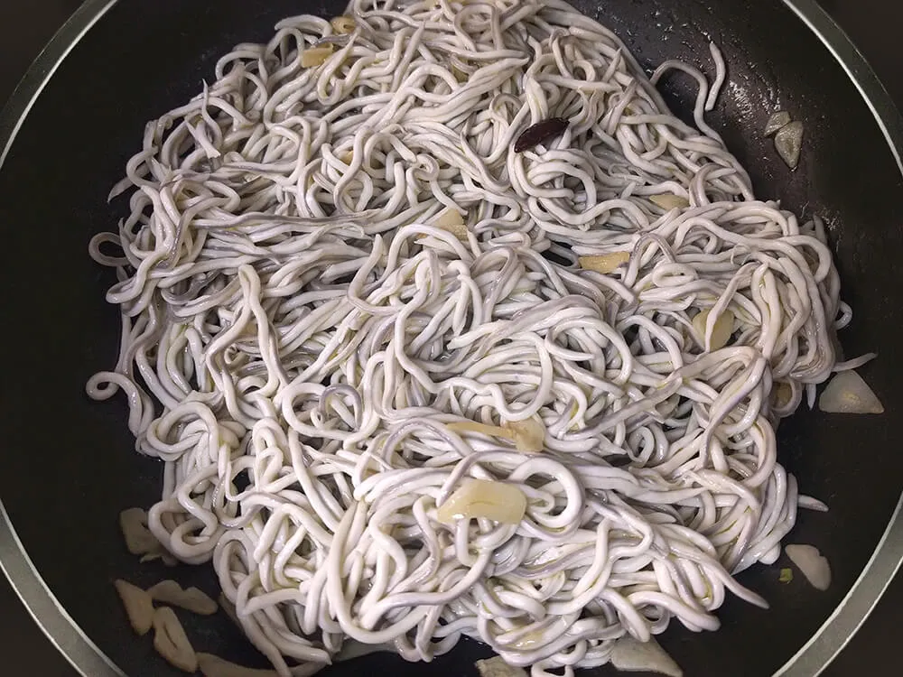 Anguriñas rehogándose con ajos y guindillas